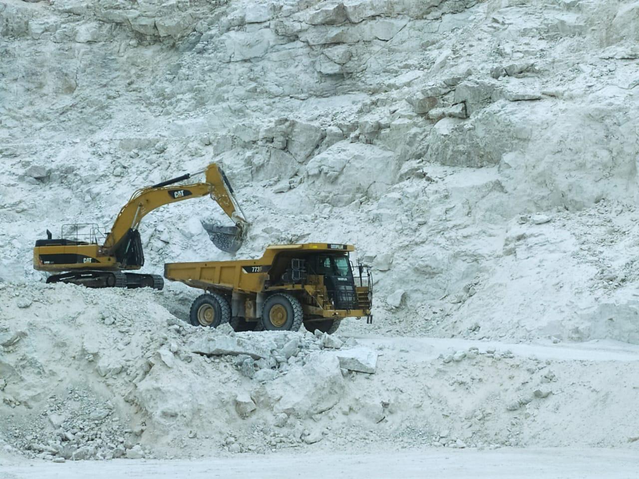 Excavator at rock face